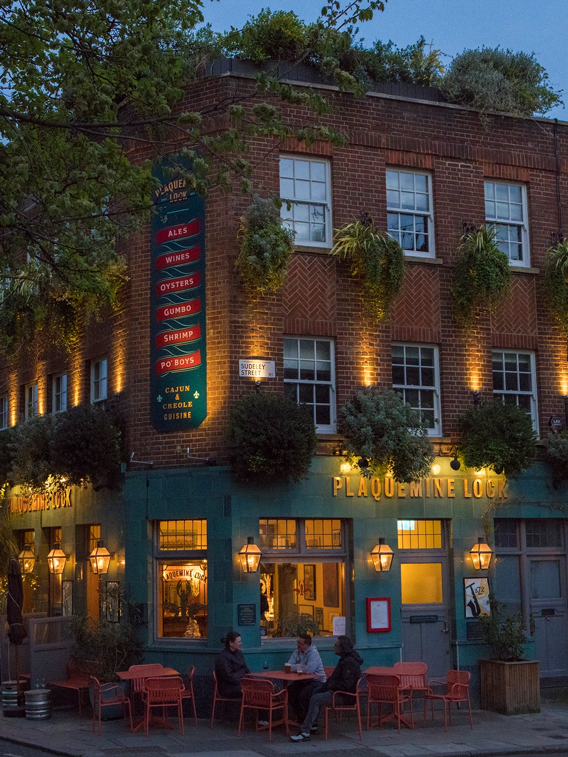 Plaquemine Lock Islington Angel Pub and Private Dining Venue Exterior of Plaquemine Lock pub restaurant in Islington Angel with outdoor seating, festive lights, and greenery, ideal for private dining and Christmas events