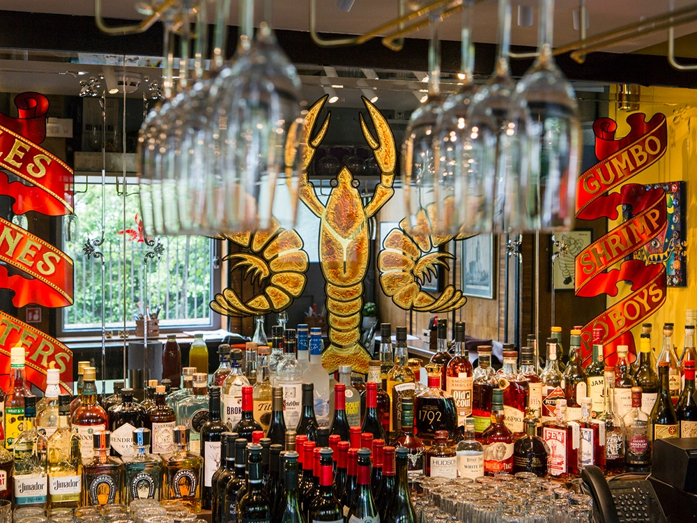 Plaquemine Lock Bar Islington Angel Bar at Plaquemine Lock Islington with spirits and crawfish artwork, a venue for private dining and Christmas hire