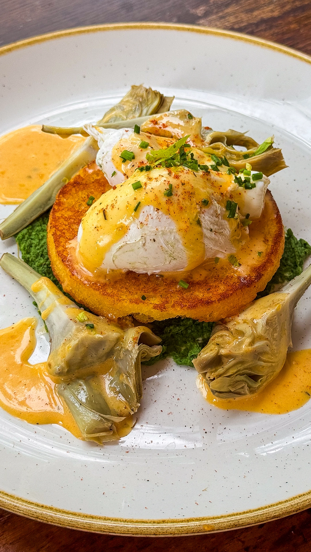 Vegetarian brunch dish with poached eggs and artichokes in Islington